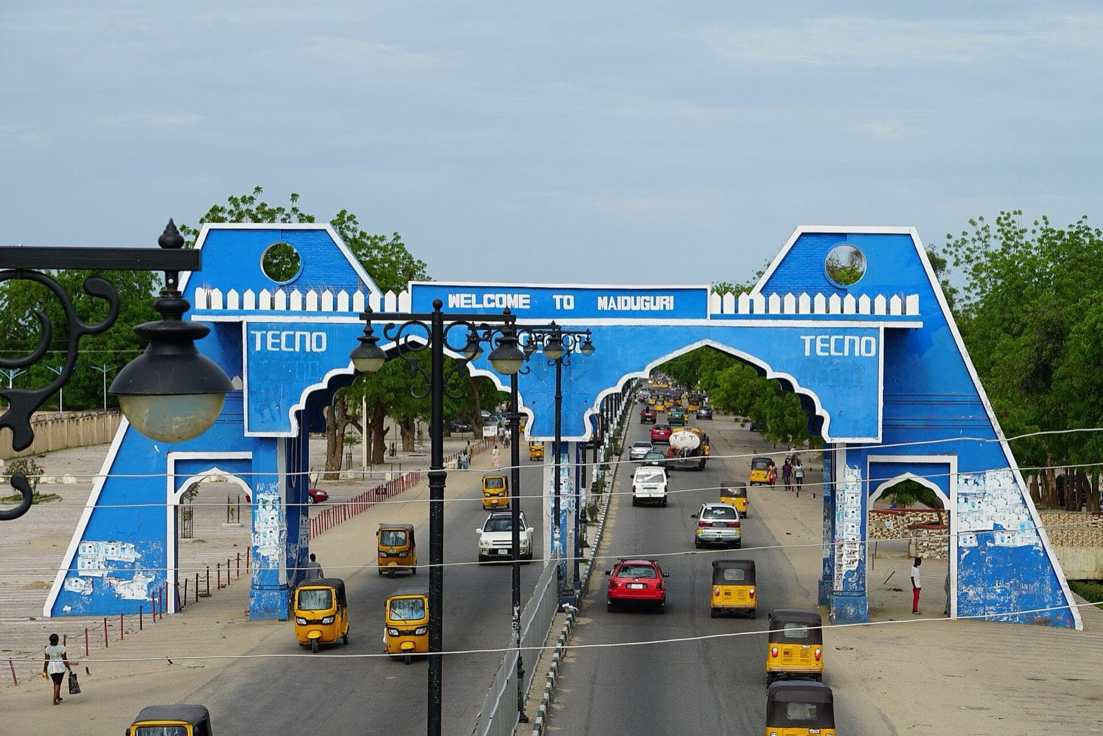 A large ceremonial city gate spanning a road into Maiduguri.