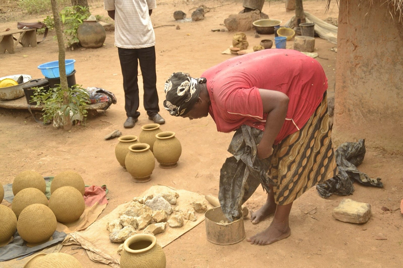 Crushed clay being poured into a soaking pot.