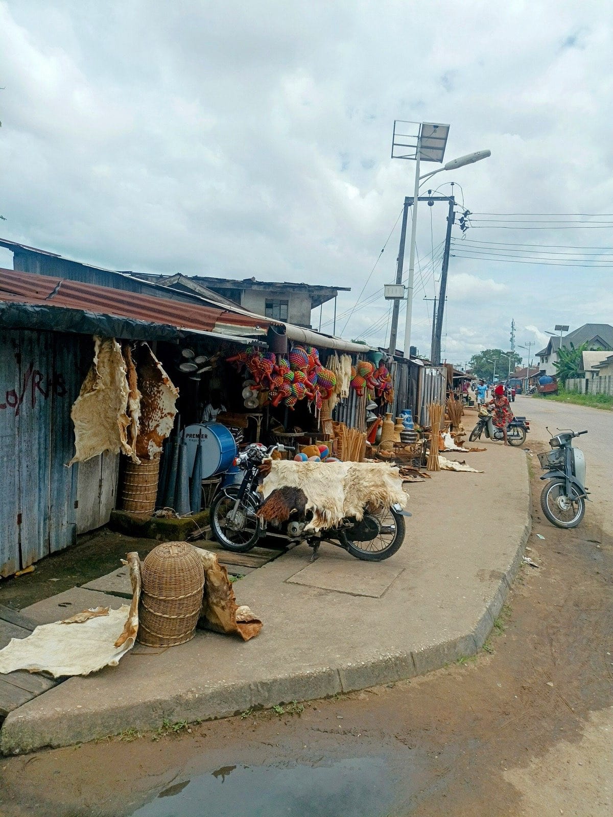 A row of workshop fronts selling raffia goods at Ikot Ekpene.