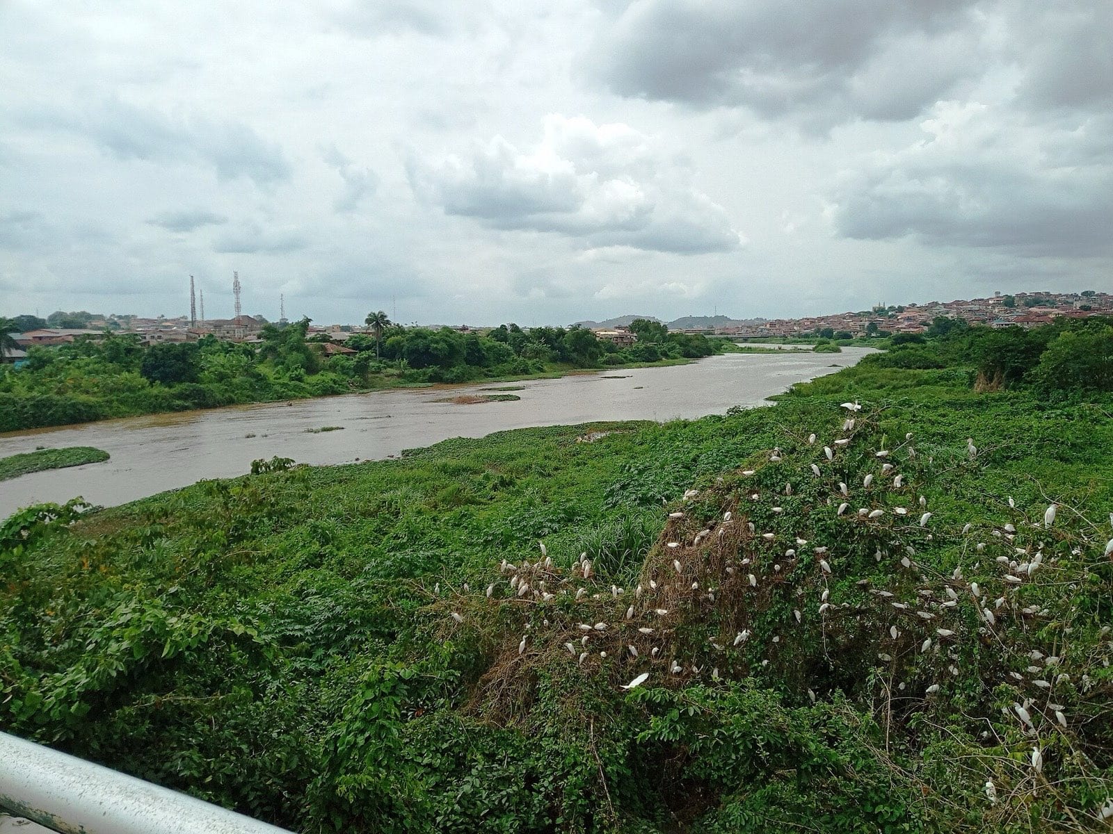 The Ogun river running past rocks below the town.