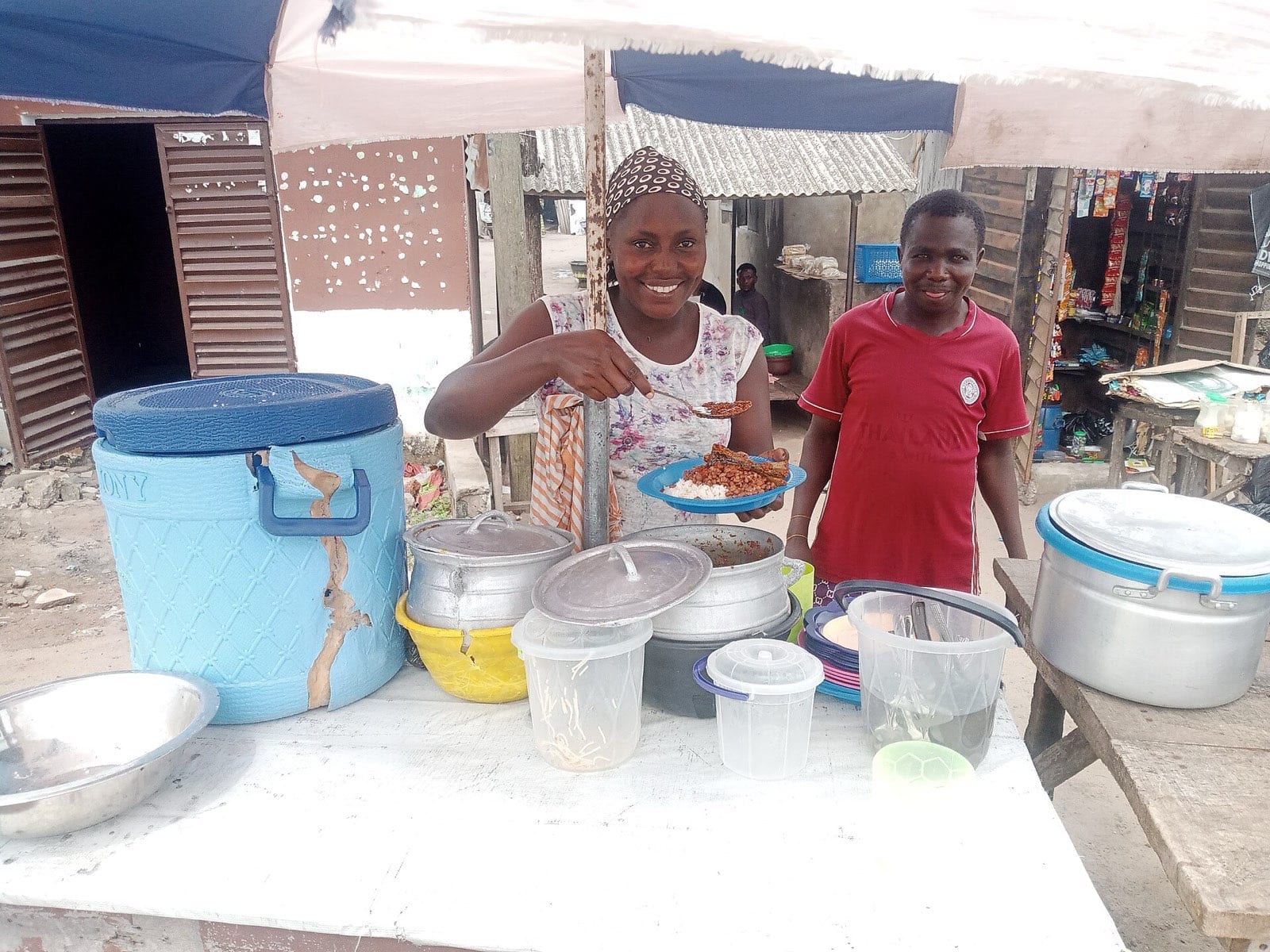 A street food vendor serving a customer.