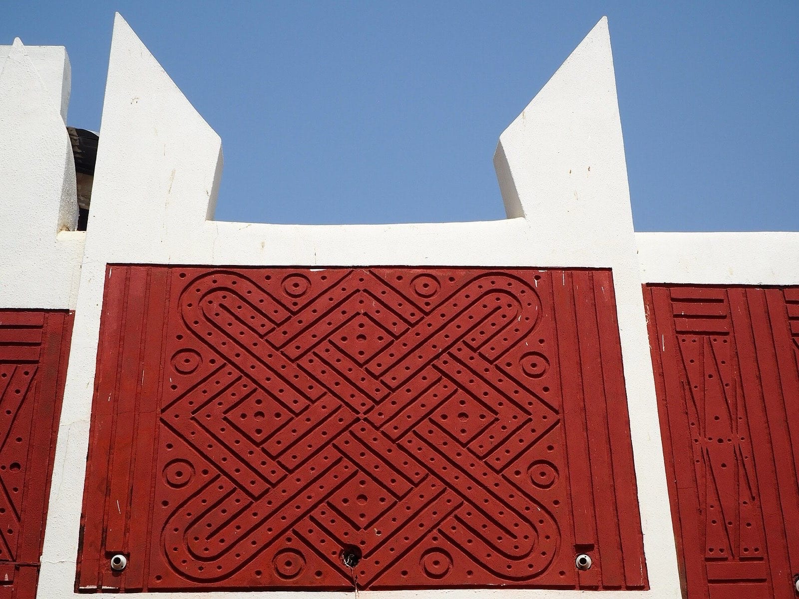 A Hausa building with a decorated façade and moulded parapet.