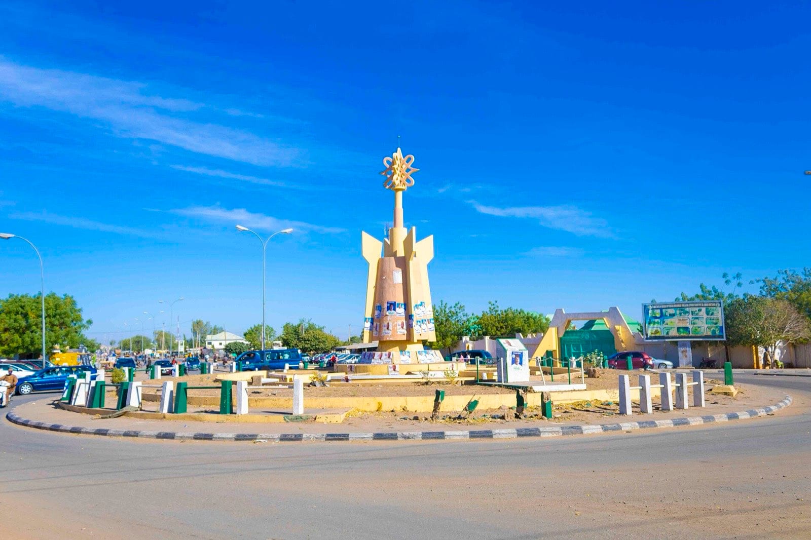 A roundabout with a steel sculpture on a main road in Katsina city.