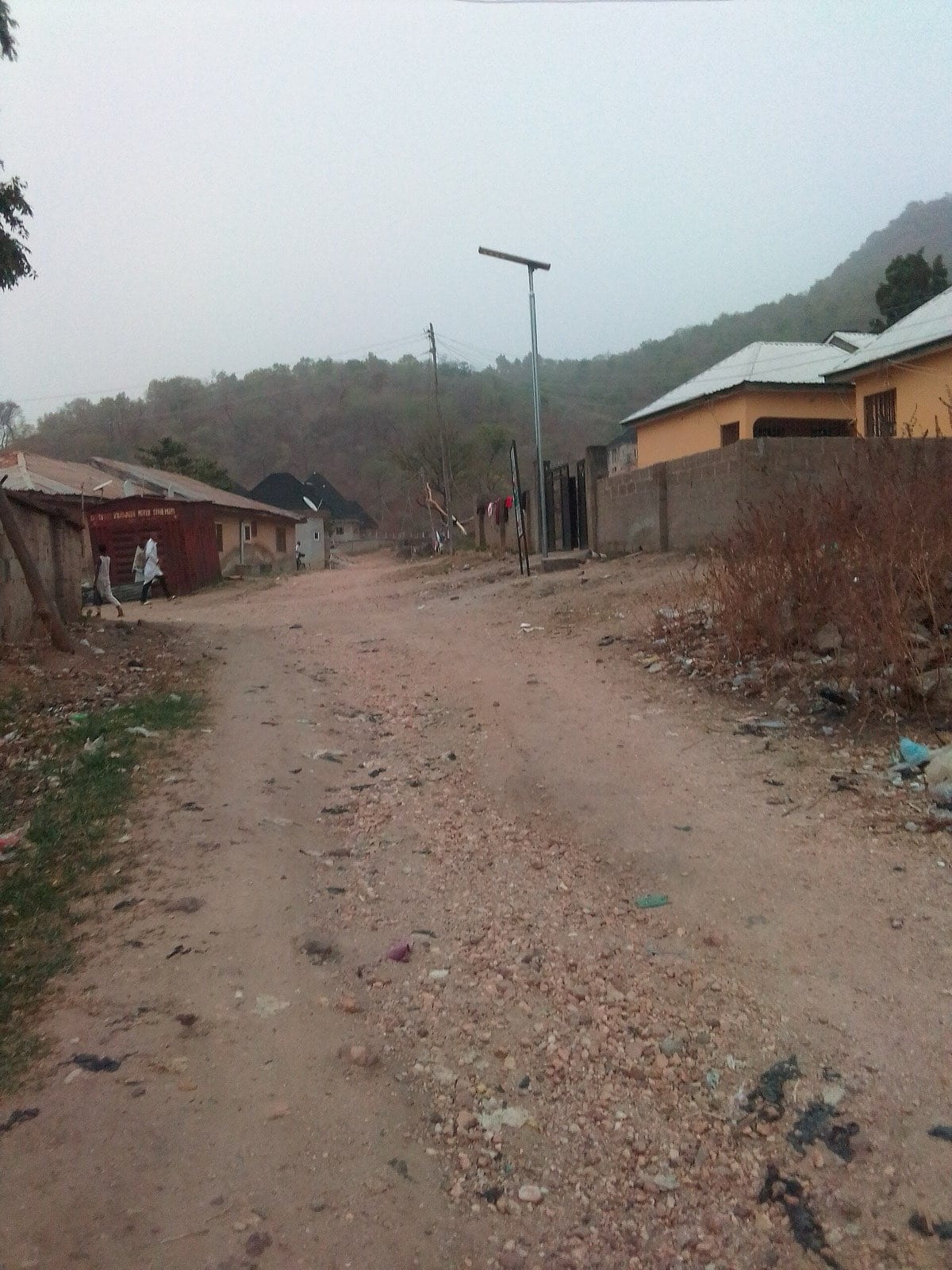 An untarred residential street in Lokoja.