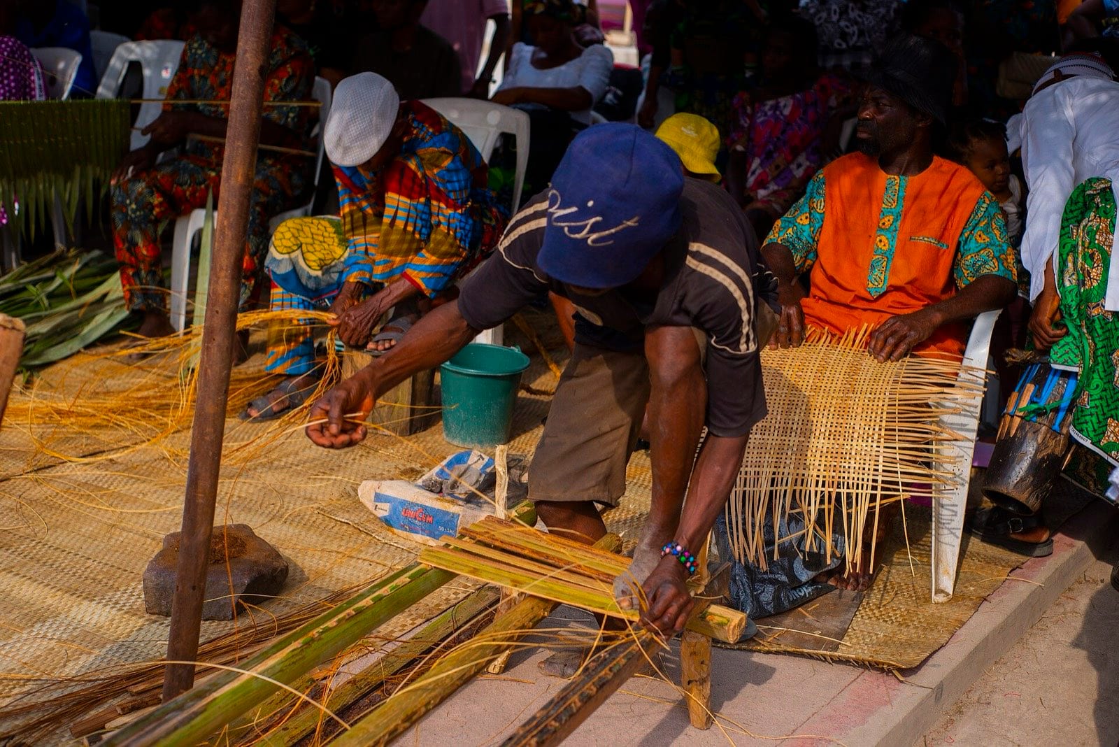 Raffia work laid out — woven palm fibre pieces in several forms.